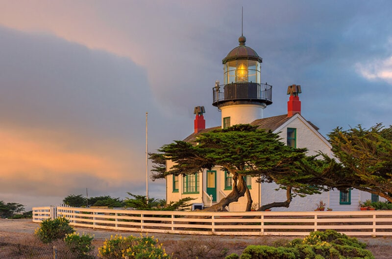 Exterior photo of the Point Pinos Lighthouse in Carmel, Ca on a sun setting, clear day.